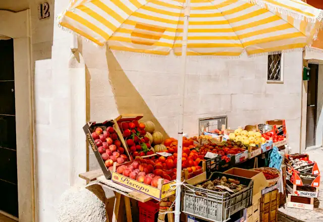 Market stall umbrella and crates of fruit for commercial kitchen rental in illinois