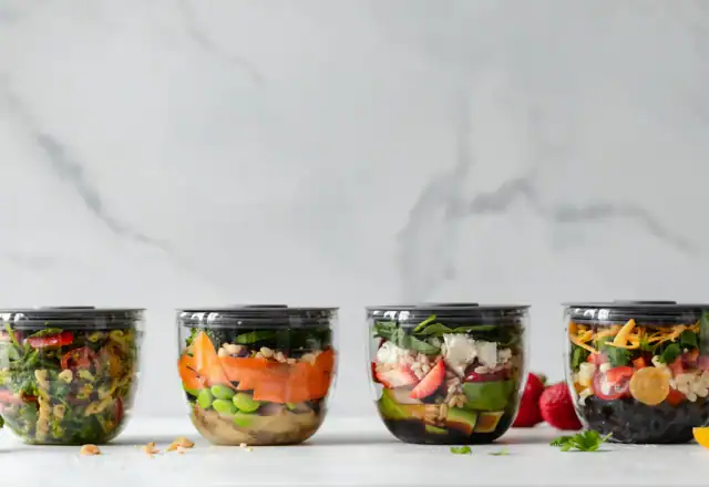 Clear containers of vegetables ready for meal prep for refrigerated storage