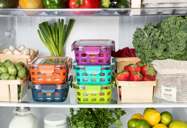 Colorful plastic food containers stacked inside a refrigerator for kitchen security and access