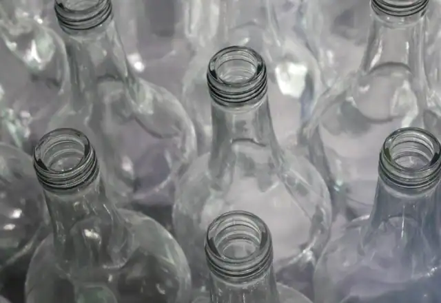 Clear glass bottles on a wooden table for cloud, dark and ghost kitchen rental