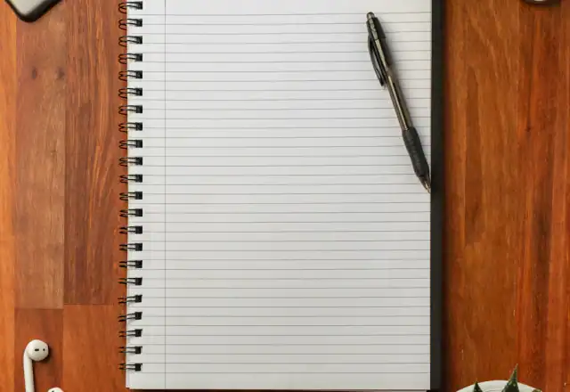 Pen on an open notebook for about us