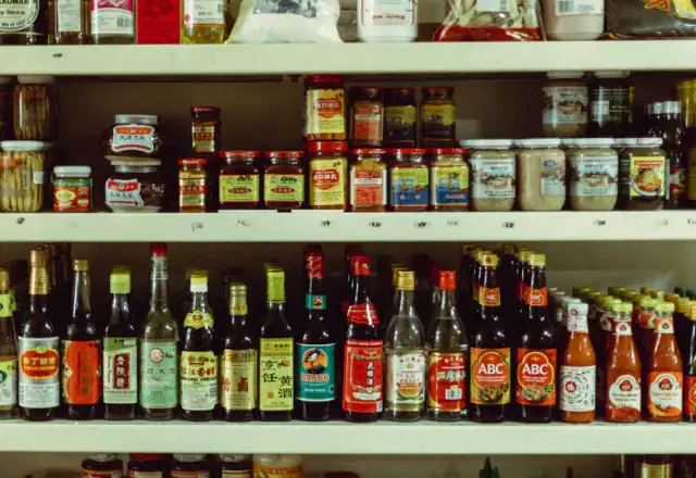 Bottles on a wooden shelf for food packaging area