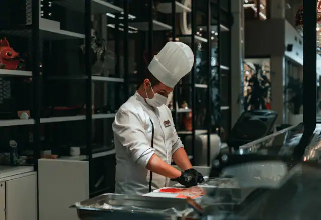 Chef preparing food in a busy kitchen for kitchen rental resource center