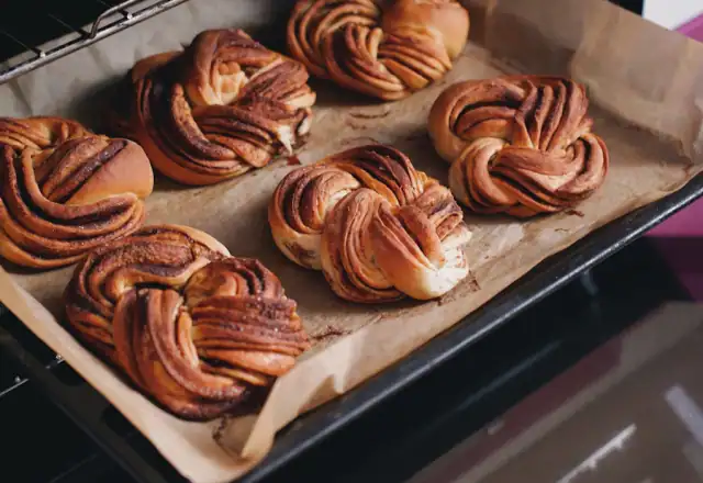 Tray of freshly baked pastries in an oven for bakery kitchen