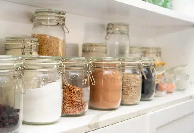 Row of jars filled with different foods for preparing to sell wholesale