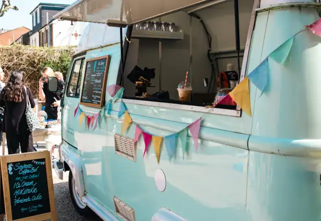Blue and white food truck parked in a lot for food truck parking and support