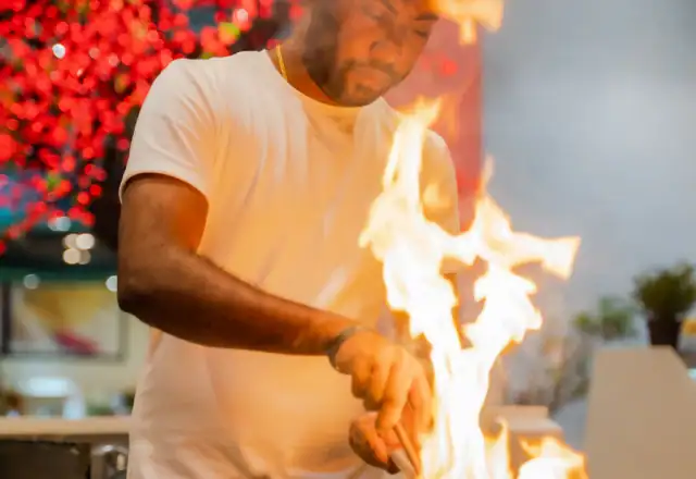 Man cooking food in a commercial kitchen for about us