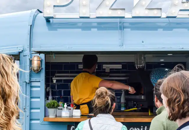 Group of people waiting at a food truck for tenant stories and reviews