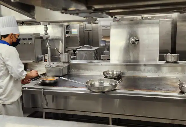 Chef cooking in a commercial kitchen for shared kitchen rental