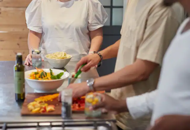 Team of cooks preparing food in a large kitchen for designing a menu for efficient production