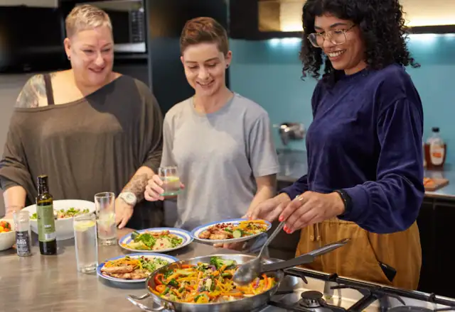Group of cooks working at a prep counter for shared kitchen rental