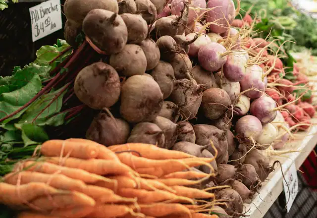 Carrots and other vegetables on a market table for commercial kitchen rental in utah