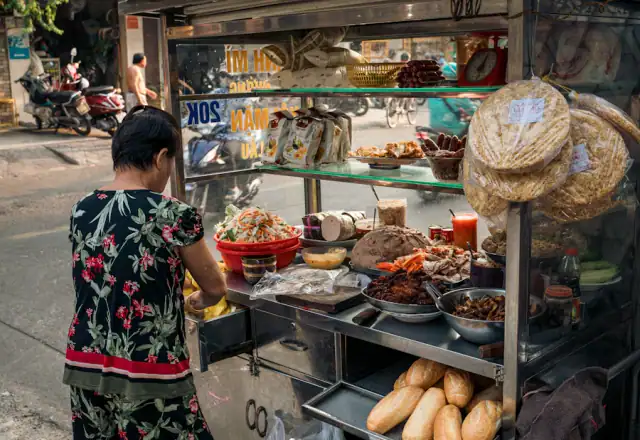 Vendor standing in front of a food cart for food truck parking and support