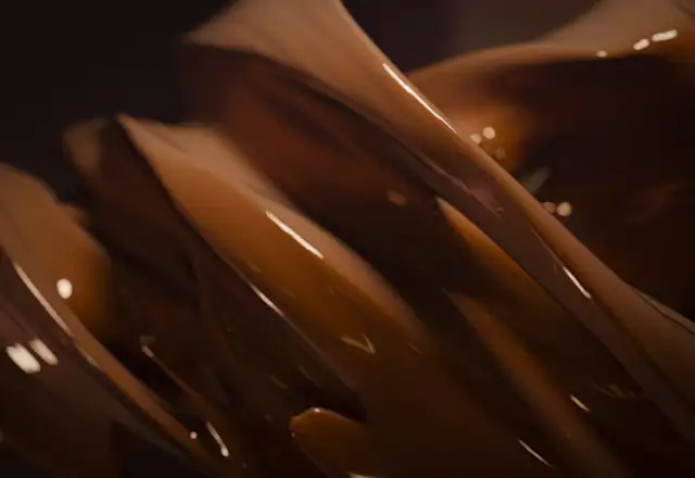 Melted chocolate flowing in a bowl for kitchen rental for confectionery makers