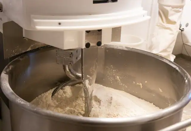 Mixer working a batch in a mixing bowl for tenant stories and reviews