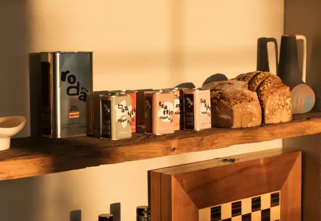 Bottles of olive oil and loaves of bread on shelves for dry ingredient and packaging storage
