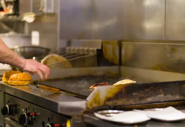 Chef preparing food on a commercial grill for what is commercial kitchen rental?