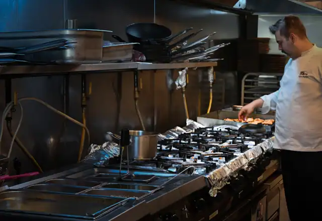 Chef cooking in a commercial kitchen for test and development kitchen hire