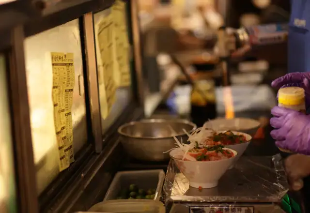 Chef finishing a dish with a torch in a kitchen for designing a menu for efficient production
